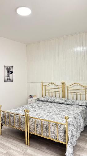 a large bed in a room with a bed frame at Casa Vacanze Nuvola in Pietralunga