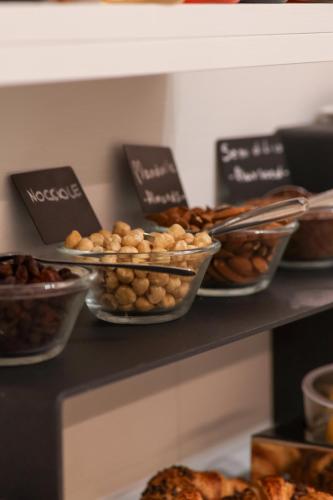 a shelf with different types of bread and pastries at Hotel Victoria in Cuneo