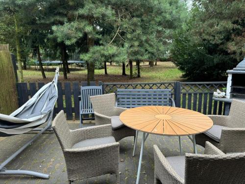 a table and chairs with an umbrella on a patio at Noclegi pod Słonecznikiem in Gąsawa