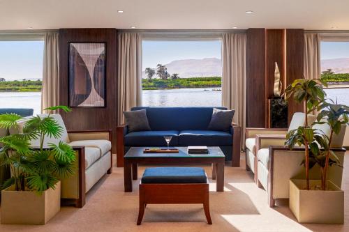 a living room with a couch and a table at Mövenpick Royal Lily Nile Cruise, Every Monday Four Nights From Luxor, Every Friday Three Nights From Aswan - Including Excursions & Sightseeing in Luxor