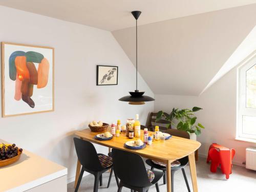 a dining room with a wooden table and chairs at Apartment Blaumuschel - LUB108 by Interhome in Lubmin