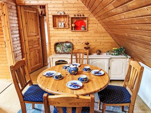 a wooden dining room with a wooden table and chairs at Apartment Brigitte by Interhome in Katzow