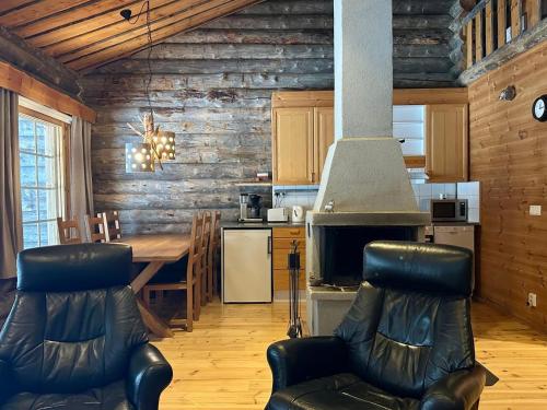 a kitchen and dining room with a table and chairs at Holiday Home Sallan savu a by Interhome in Salla