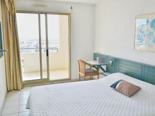 une chambre avec un lit, un bureau et une fenêtre dans l'établissement Apartment L'Open-10 by Interhome, à Fréjus