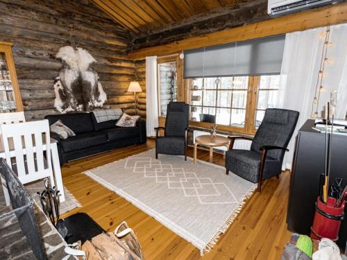 a living room with a couch and chairs at Holiday Home Sallan savu e by Interhome in Salla