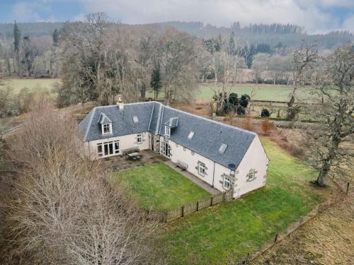 an aerial view of a white house with a gray roof at Holiday Home Old Stables by Interhome in Drumnadrochit