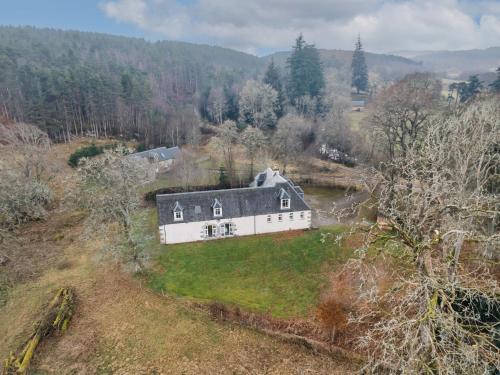 an aerial view of a large white house on a hill at Holiday Home Old Stables by Interhome in Drumnadrochit