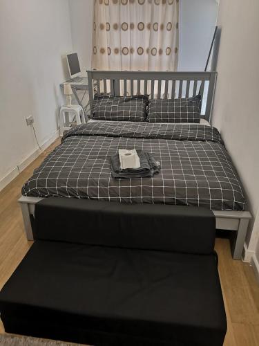 a bed in a bedroom with a hat on it at Lascelles house - a few mins to US Embassy, Battersea Power Station & Central London in London