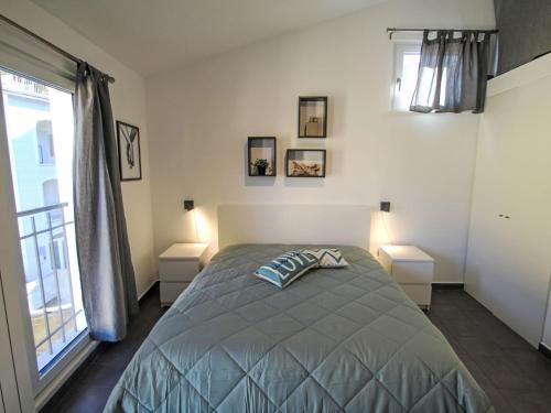 a bedroom with a bed with two night stands and a window at Apartment Casina al Lago by Interhome in Lavena Ponte Tresa