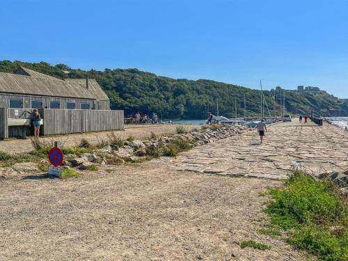 a group of people walking on a stone path near the water at Apartment Markus - 300m from the sea by Interhome in Allinge