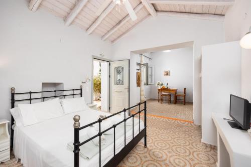 a bedroom with a bed and a living room at Aimilia Cottage in Longos