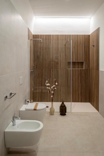 a bathroom with a sink and a toilet and a shower at Casa Pavò in Bari
