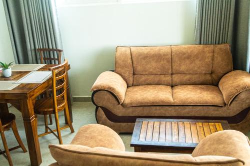 a living room with a couch and a table at Cocos in Midigama