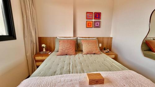 a small bedroom with a bed with two pillows at Apartment JC 903: Jardim Camburi. Vitória- E.S. in Carapina