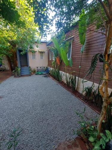 a house with a gravel driveway in front of a house at La casa de MaCa in Posadas