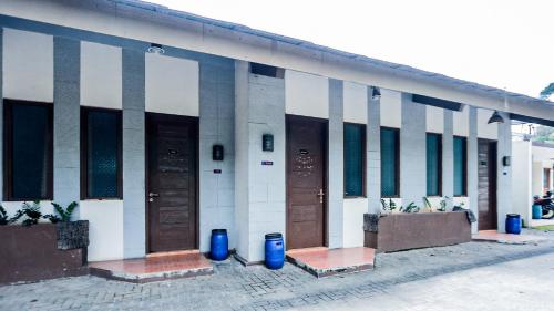 a building with a bunch of doors on it at Lembah Gunung Kujang by ARBA in Gunungtua