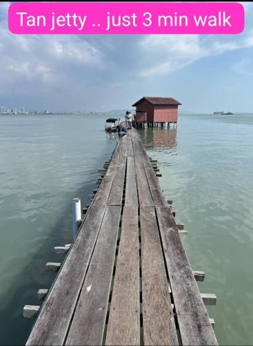 a wooden dock in the middle of the water at Hotel Lang Hoose in George Town