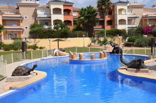 a pool at a resort with elephants in the water at Planta baja con gran terraza y jardín Altaona golf in Murcia