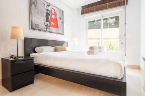 a bedroom with a large bed and a window at Seaside stay with large terrace, pool & parking REMS in Benalmádena