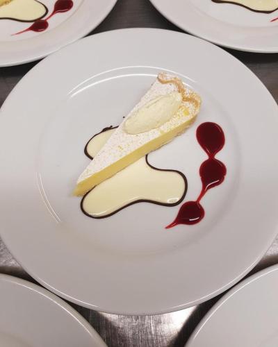 a white plate with a piece of food on it at Brook Hall Hotel in Childer Thornton