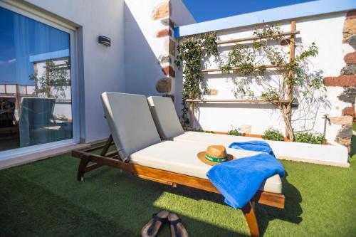 a chair on a lawn with a hat on it at Hotel Rural Rosario Martin in Puerto del Rosario