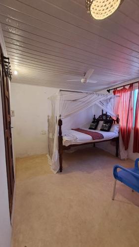 a bedroom with a canopy bed in a room at Roof Top House in Lamu