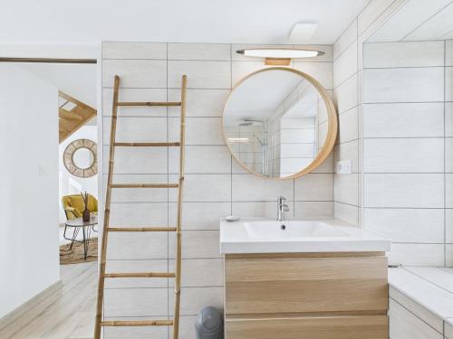 a bathroom with a ladder next to a sink at Maison de campagne avec grand jardin pour 8 in Plouguerneau