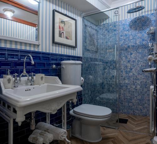 Un baño con inodoro, lavabo y ducha. en Regal House Roma Capucci 6, en Roma