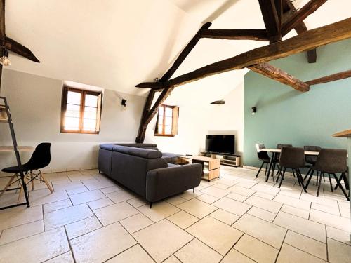 un salon avec un canapé, une table et des chaises dans l'établissement Résidence Nation, à Bourges