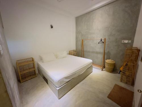 a bedroom with a white bed in a room at Onara Home Koggala in Habaraduwa