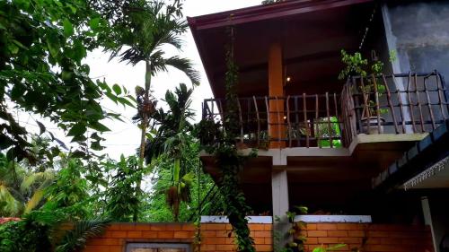 a house with a balcony on the side of it at Onara Home Koggala in Habaraduwa