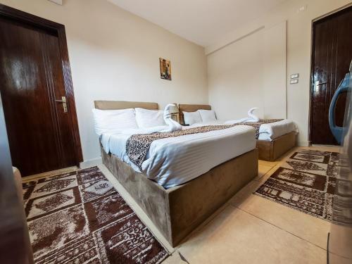 a bedroom with two beds in a room at Hur magic pyramids Hotel in Cairo
