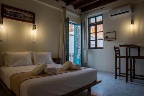 a bedroom with a bed with towels on it at Vavana Studios in Symi