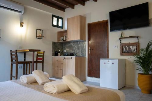a bedroom with a bed with two pillows on it at Vavana Studios in Symi