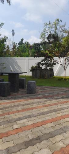 a park with two benches and a white fence at Airport A4 Travelers Lodge - Free Airport Pick Up & Drop 24HRS in Katunayake