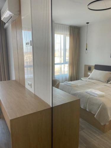 a bedroom with a bed and a mirror at Villa Vitosha Apartments in Hisarya