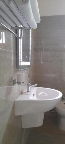 a bathroom with a white sink and a toilet at Airport A4 Travelers Lodge - Free Airport Pick Up & Drop 24HRS in Katunayake