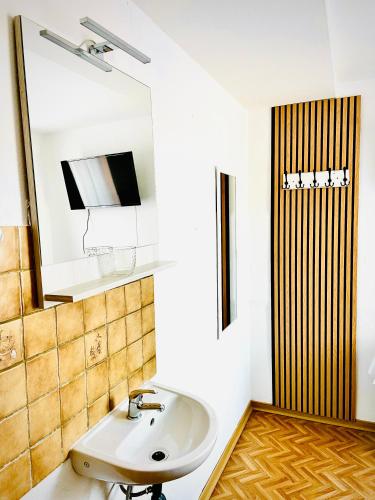 a bathroom with a sink and a mirror at Just Pension & Bar in Gadebusch