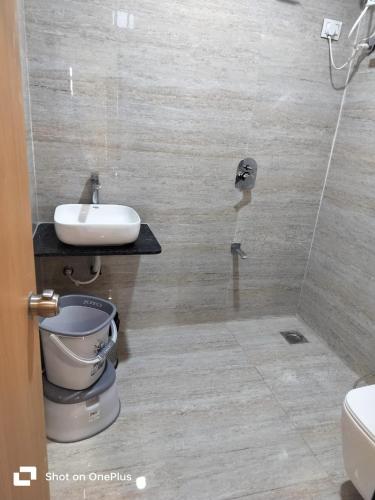 a bathroom with a toilet and a sink at Amazing Fun World By Nexottel in Dwarka