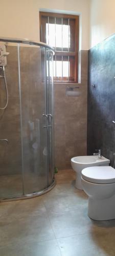 a bathroom with a glass shower and a toilet at Airport A4 Travelers Lodge - Free Airport Pick Up & Drop 24HRS in Katunayake