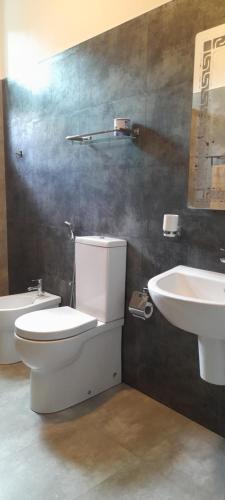 a bathroom with a toilet and a sink at Airport A4 Travelers Lodge - Free Airport Pick Up & Drop 24HRS in Katunayake