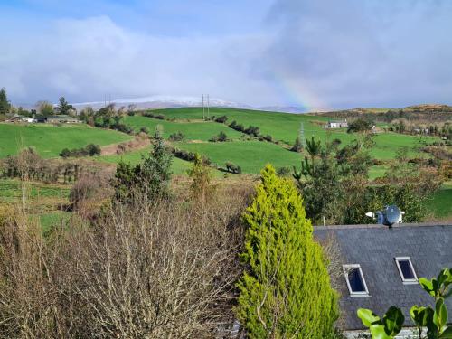 a view of a farm with a house and trees at Gouladoo Retreat in Bantry