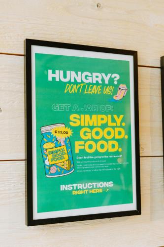 a poster on the wall of a kitchen with at Daft Hotel in Malmedy