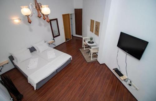a bedroom with a bed and a flat screen tv at Apartments Isabella in Mostar