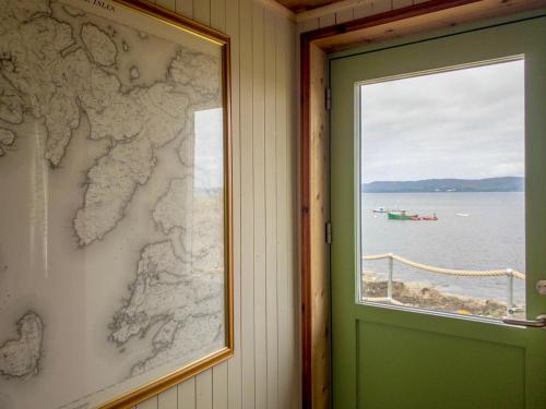 a window with a map on the wall next to a door at Doune Knoydart in Airor