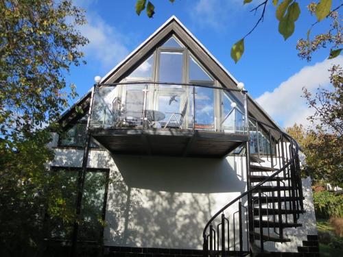 a glass house with a spiral staircase on top of it at RügenHerz DACHTRÄUME Atelierwohnung 1 - 4 Personen in Parchtitz
