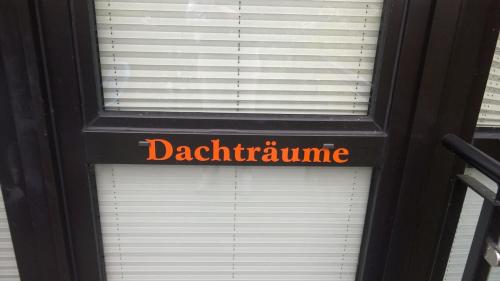 a window with a sign that reads dachrine at RügenHerz DACHTRÄUME Atelierwohnung 1 - 4 Personen in Parchtitz
