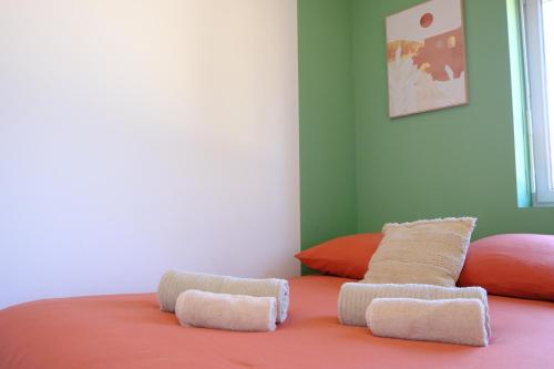 a bed with two pillows on top of it at Your Home Loos Lille in Loos
