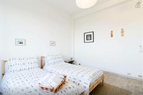 a white bedroom with a bed with white sheets at Casa Vacanze Via Marconi in Marotta