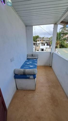 a room with two beds on a balcony at Roof Top House in Lamu